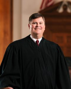 Image of a smiling man in judicial robe (Keith Meyer)